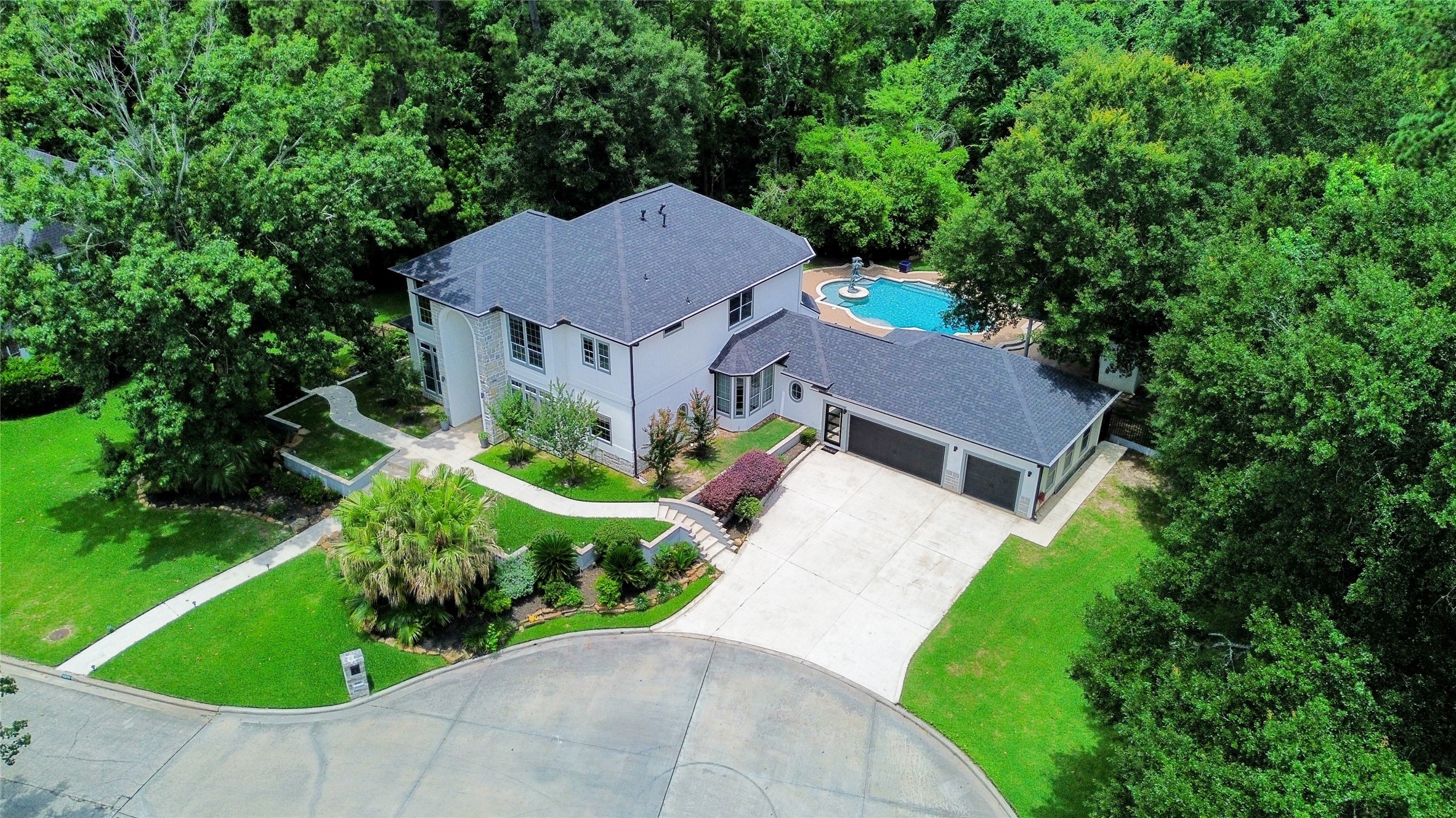 1810 Woerner Road Houston, TX 77090 - Photo 5 of 39 Discover this stunning two-story home nestled in a lush, private setting. Featuring a spacious driveway, elegant landscaping, and a luxurious backyard pool, this property offers the perfect blend of comfort and style.