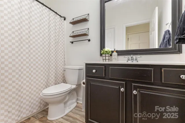 a bathroom with a sink toilet and mirror