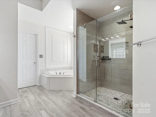 a bathroom with a bathtub and a shower