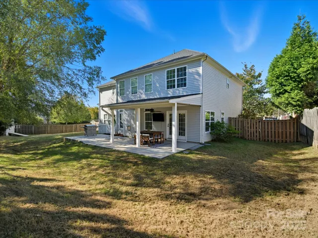 a view of a house with backyard porch and sitting area