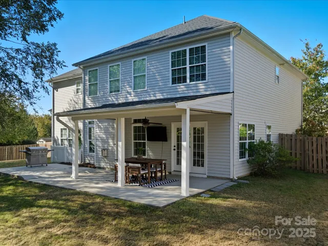 a view of a house with backyard porch and sitting area