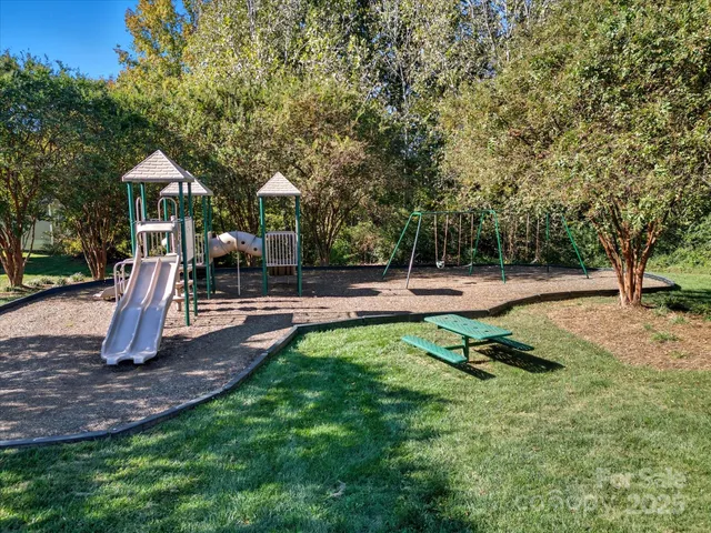 a view of outdoor space with playground and green space