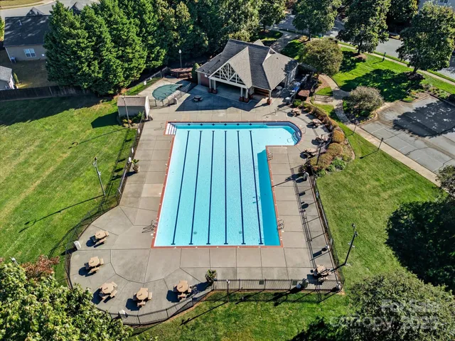 an aerial view of a house with a garden and deck