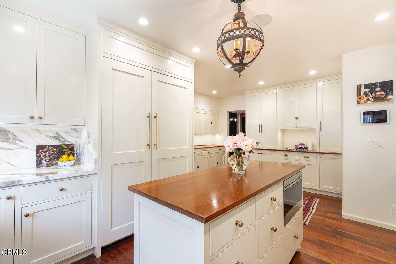 735 Holladay Road Pasadena, CA 91106 - Photo 15 of 72 a kitchen with white cabinets and chandelier