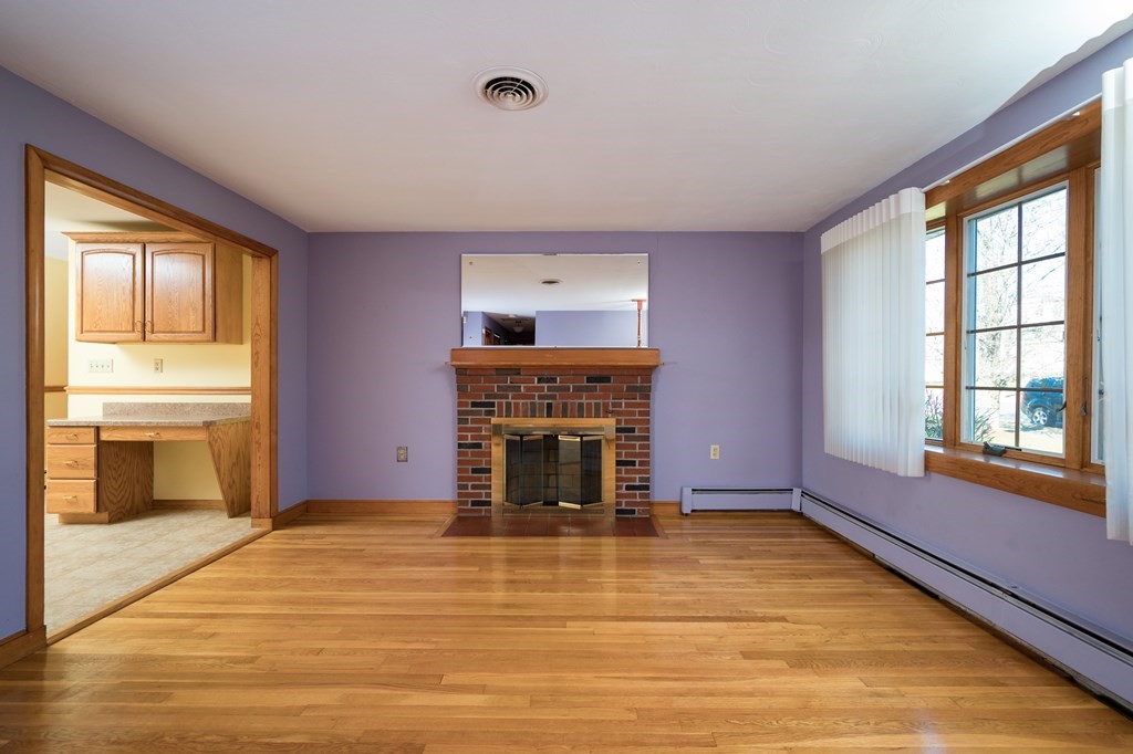 31 Andersen Road Braintree, MA 02184 - Photo 3 of 36 a view of an empty room with a fireplace and a window