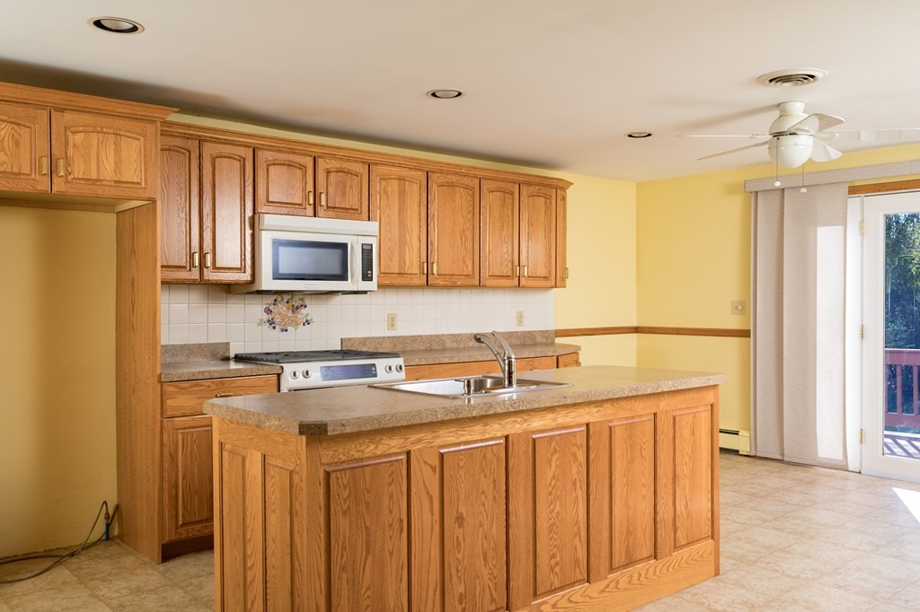 31 Andersen Road Braintree, MA 02184 - Photo 8 of 36 a kitchen with stainless steel appliances granite countertop a sink stove and refrigerator