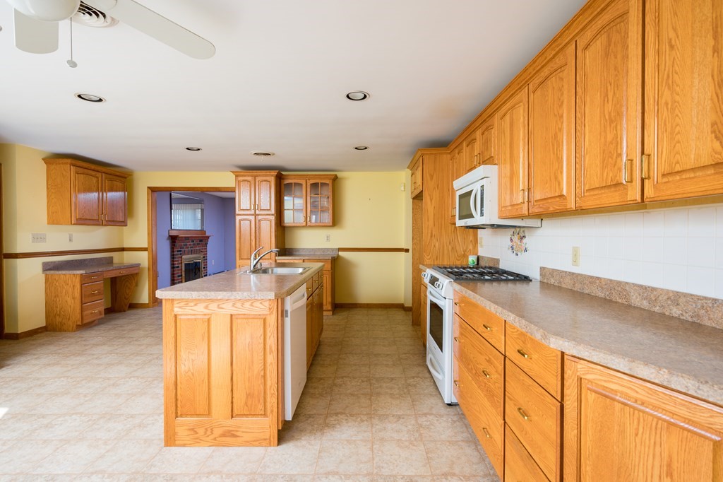31 Andersen Road Braintree, MA 02184 - Photo 10 of 36 a large kitchen with stainless steel appliances granite countertop a stove a sink dishwasher and a refrigerator