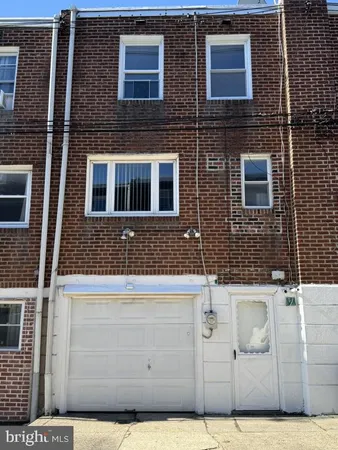 a view of a brick house with large windows