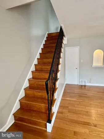 a view of entryway and hall with wooden floor