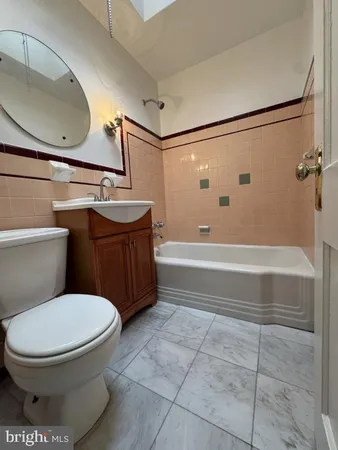 a bathroom with a toilet a sink and bathtub