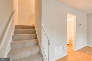 a view of staircase with white walls and windows