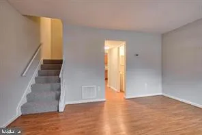 a view of an entryway with wooden floor