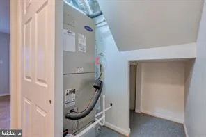 a view of a livingroom with table and a mirror