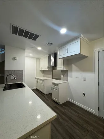 a kitchen with sink and cabinets