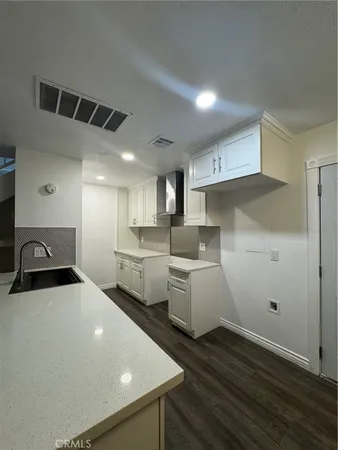 a kitchen with sink and cabinets