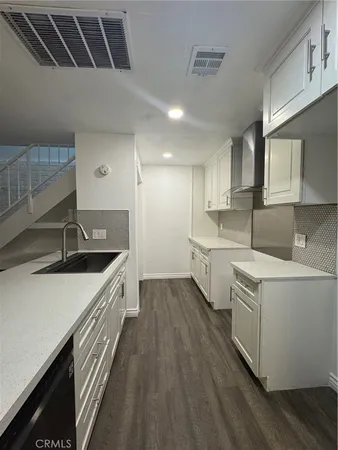 a kitchen that has a sink and a stove