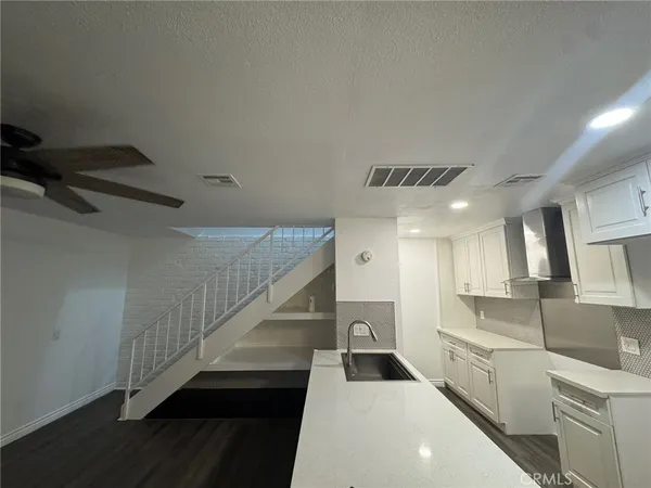 a kitchen with cabinets a sink and appliances
