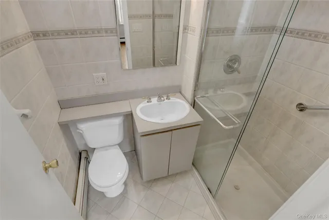 a white toilet sitting next to a bath tub