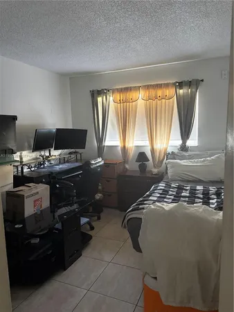 a bedroom with a bed and lamp