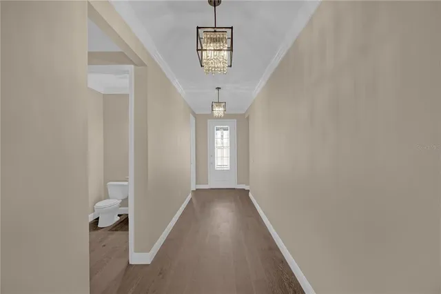a kitchen with white cabinets and sink