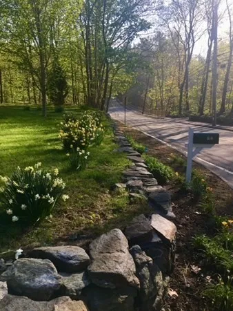 a backyard of a house with a yard and outdoor seating
