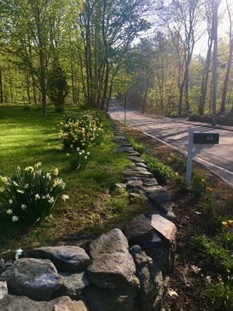 a backyard of a house with a yard and outdoor seating