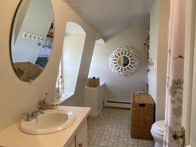 a bathroom with a toilet sink and mirror