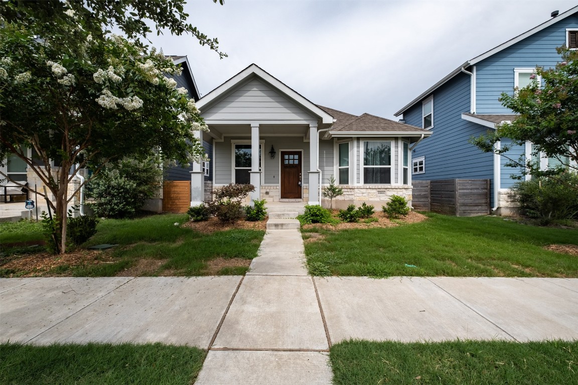 8908 Cattalo Lane, Unit A Austin, TX 78747 - Photo 1 of 1 a front view of a house with a yard and trees