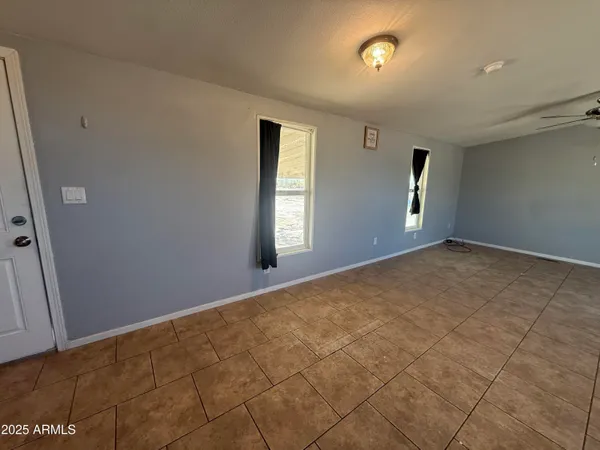 an empty room with windows and closet