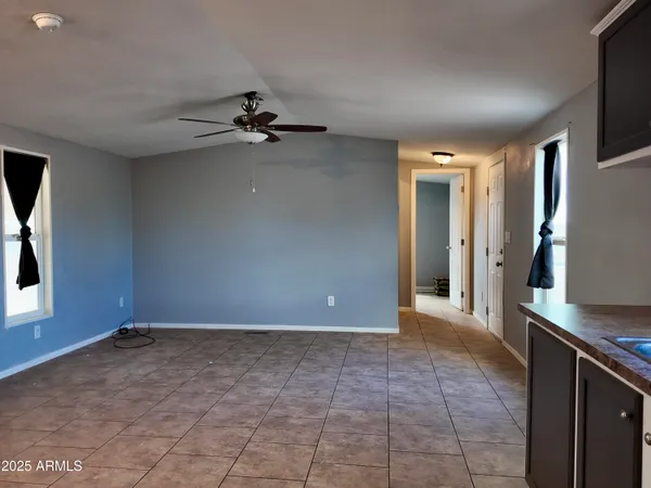 a view of a kitchen with a sink and a refrigerator