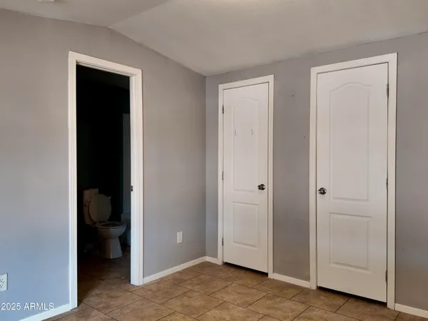 a view of an empty room with closet area