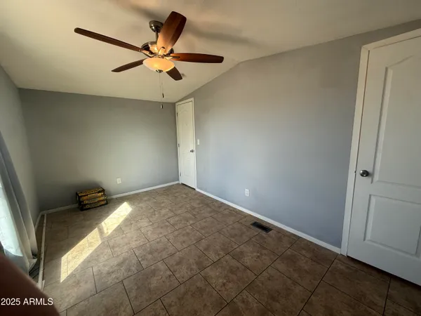 a view of a livingroom with a ceiling fan and window