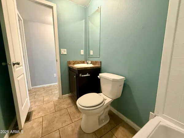 a bathroom with a granite countertop sink toilet mirror and shower