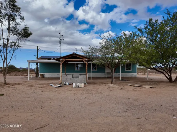 a view of a house with a yard and tree