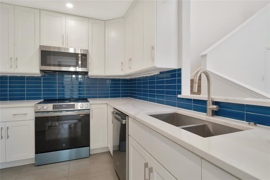 2909 Normandy Court Euless, TX 76039 - Photo 13 of 36 a kitchen with a sink and a stove top oven