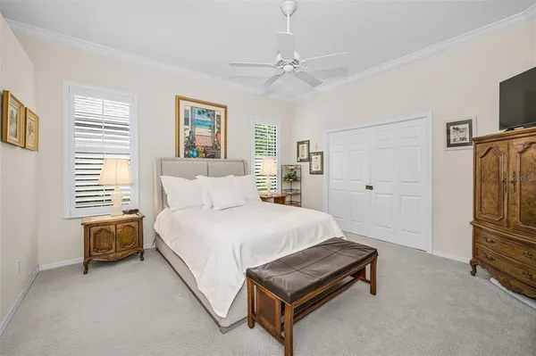 a spacious bedroom with a bed and a chandelier