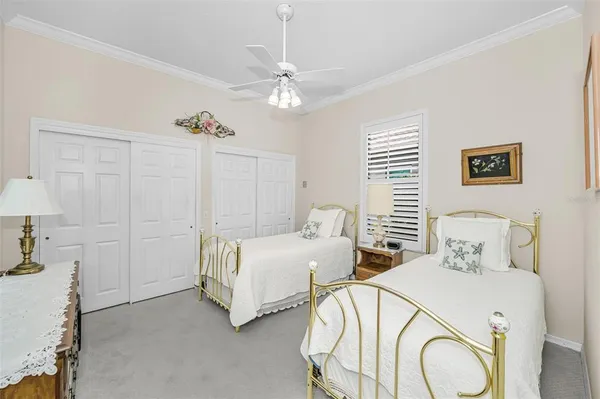 a bedroom with two beds and a chandelier