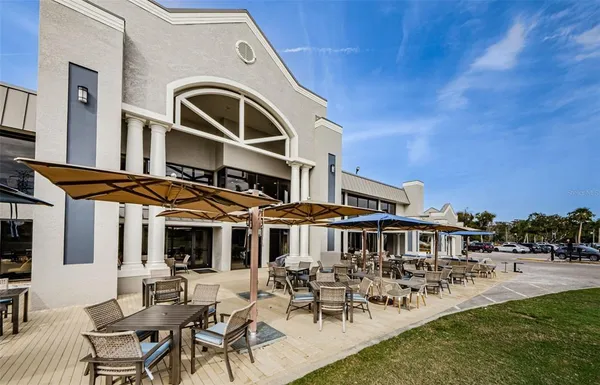 a front view of a building with outdoor seating