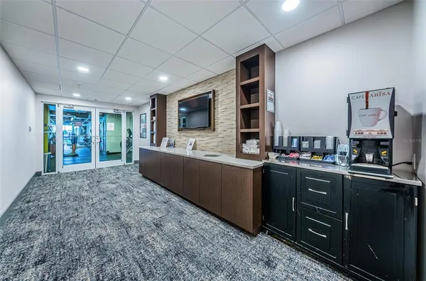 a living room with granite countertop furniture and a flat screen tv