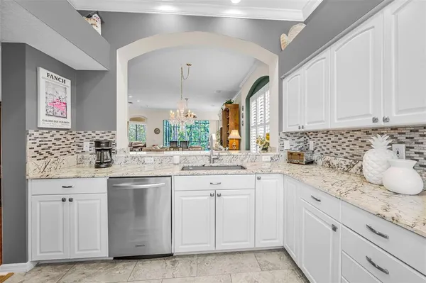 a kitchen with sink cabinets and window