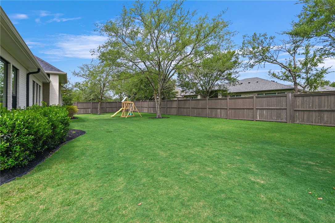 5115 Inverness Drive Bryan, TX 77802 - Photo 27 of 28 Yard featuring grass and fence