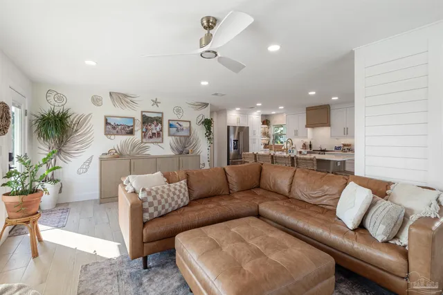 a view of a living room kitchen and a large window