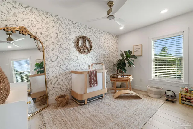 a bedroom with a bed window and a flat screen tv