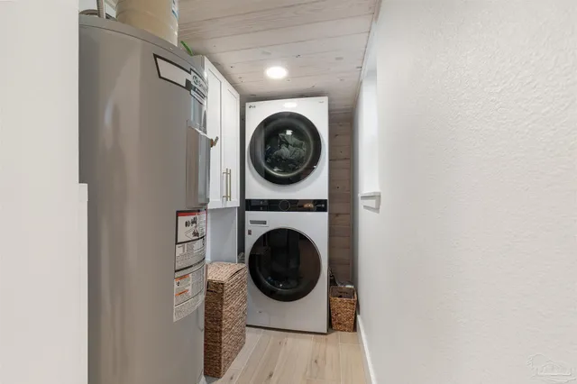a view of a hallway with wooden floor and a couch