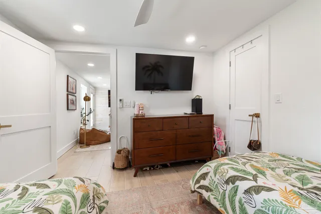 a bedroom with a bed and wooden floor