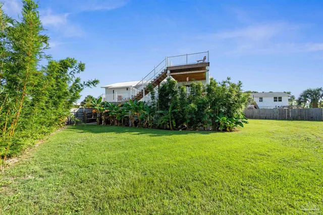 an aerial view of a houses with a lake