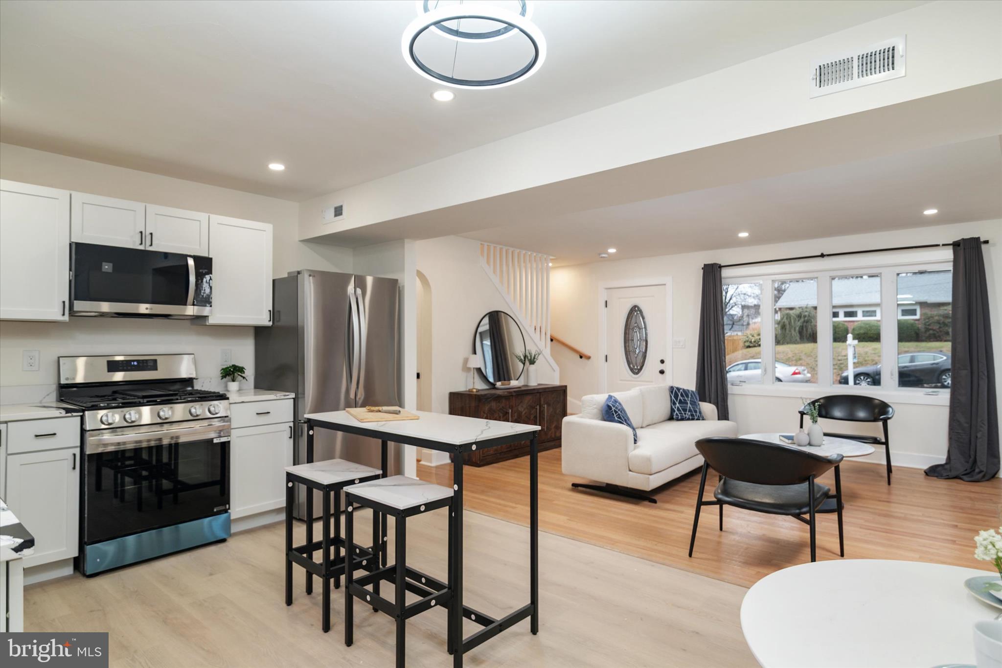 36 East George Street Westminster, MD 21157 - Photo 12 of 33 a living room with stainless steel appliances furniture a rug and a kitchen view