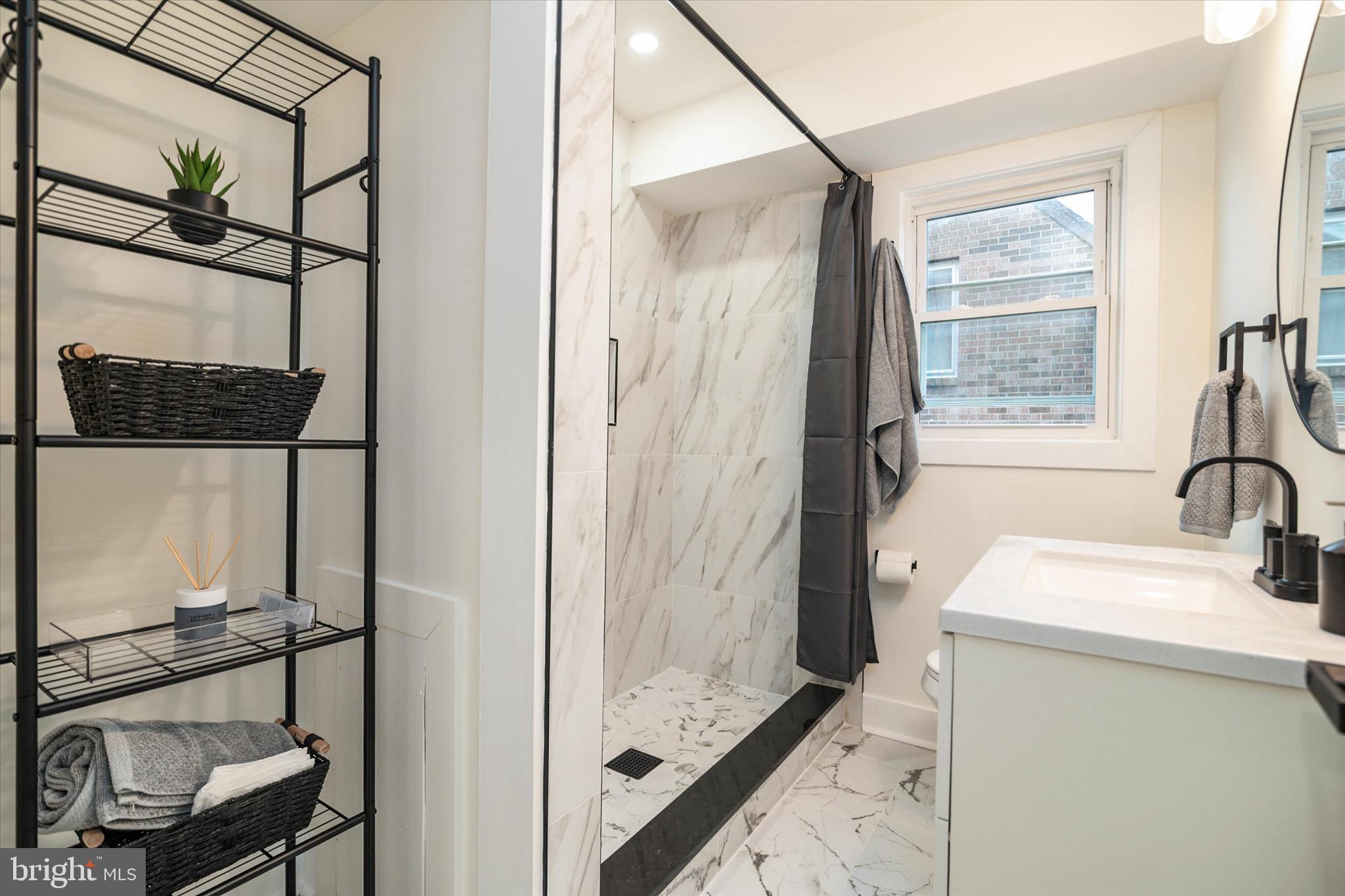 36 East George Street Westminster, MD 21157 - Photo 17 of 33 a bathroom with a sink a mirror and a shower