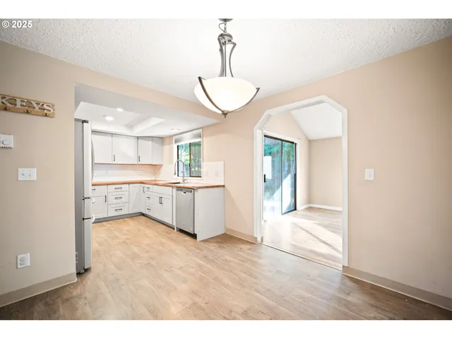 a view of a kitchen with a sink and a window