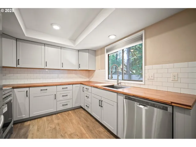 a kitchen with sink cabinets and window